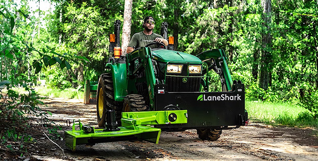 LaneShark man driving tractor