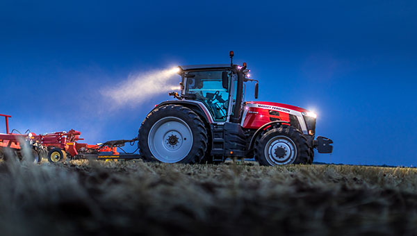 Massey Ferguson 8s tractor in the field at night